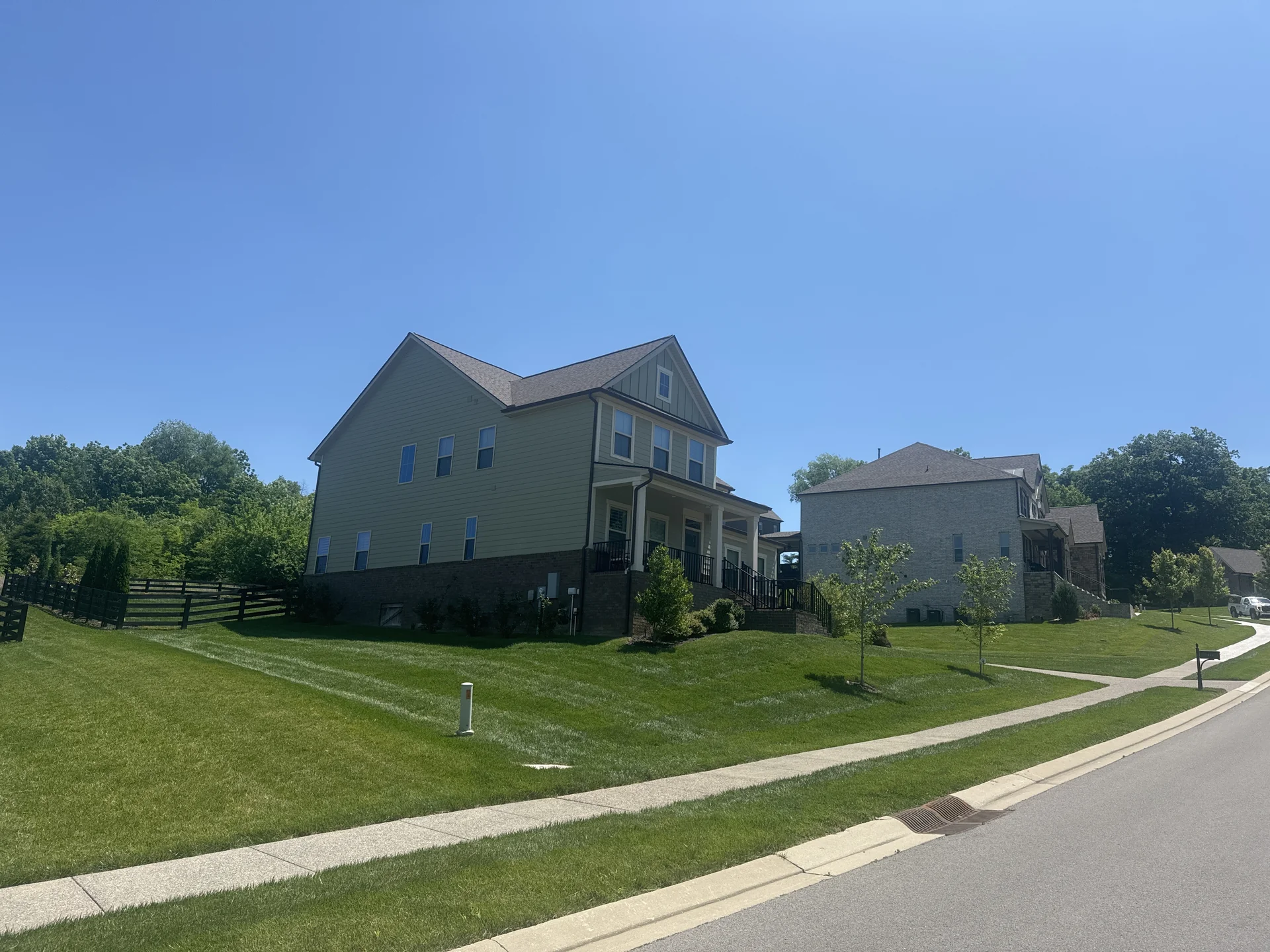 Beautiful Fescue Lawn with a Neighbors Less Lush Lawn Beside It — Mr. Lawn Care, Middle Tennessee lawn treatment