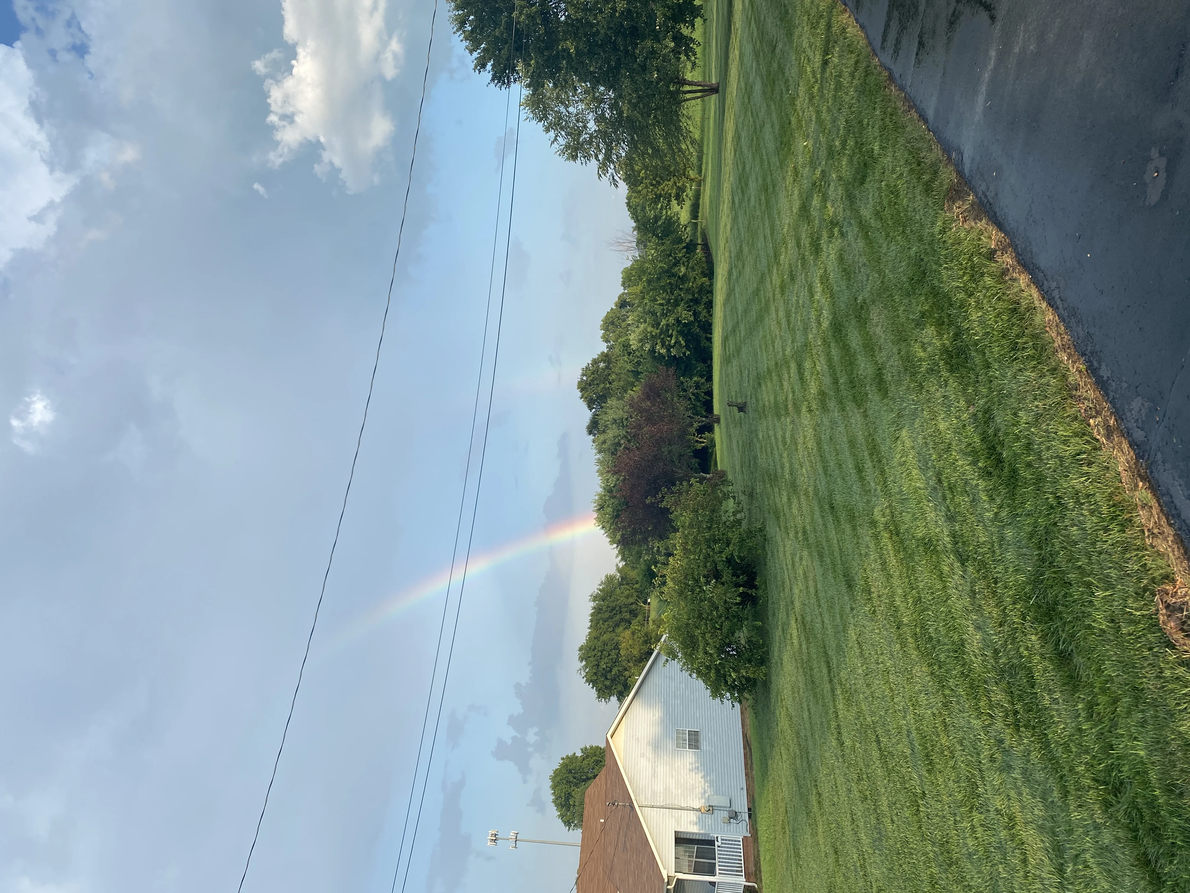 Vibrant Rainbow Over Green Residential Lawn — Mr. Lawn Care, Middle Tennessee lawn treatment