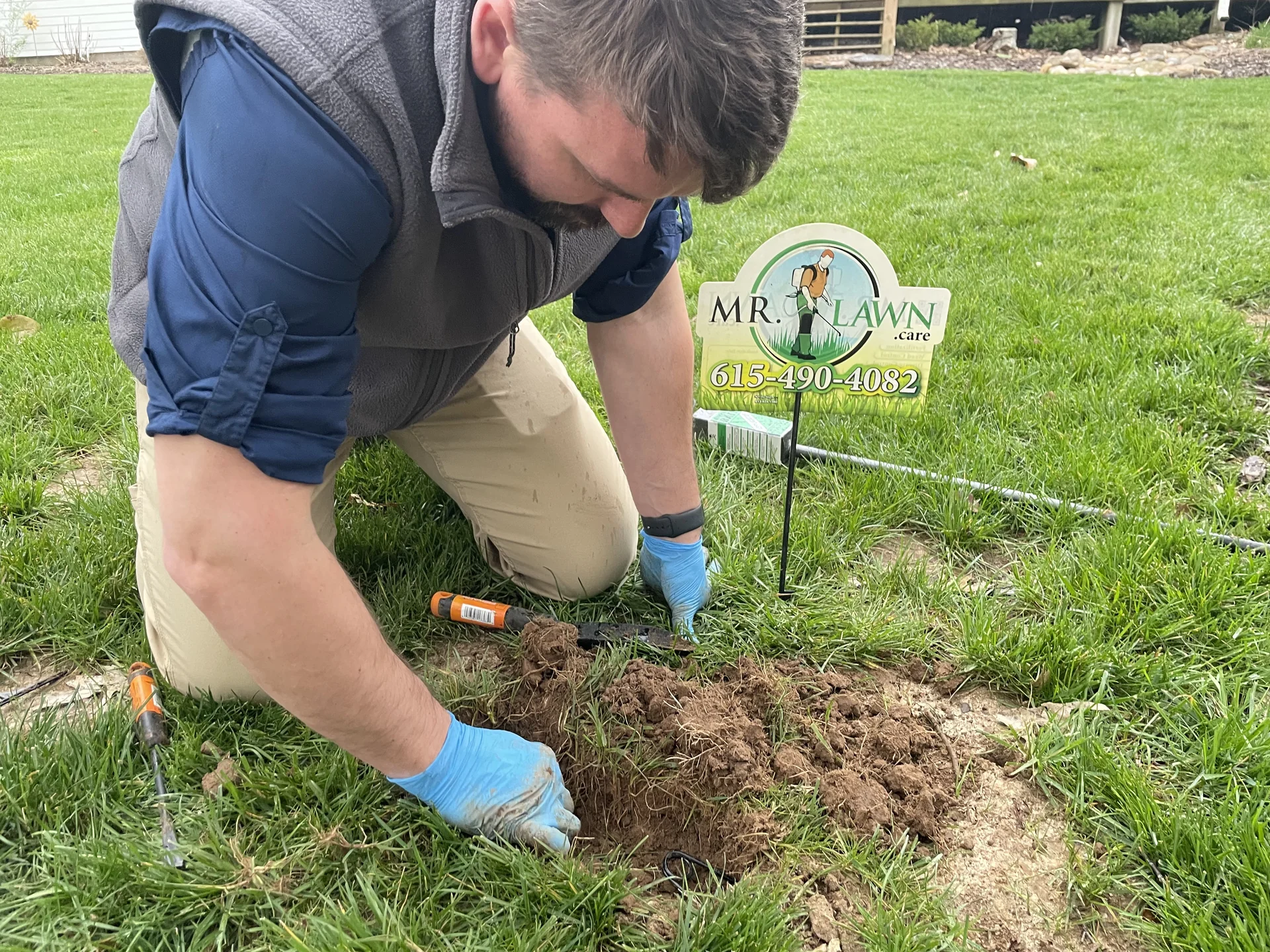 Placing a professional mole trap in a Middle Tennessee lawn — Mr. Lawn Care mole control service